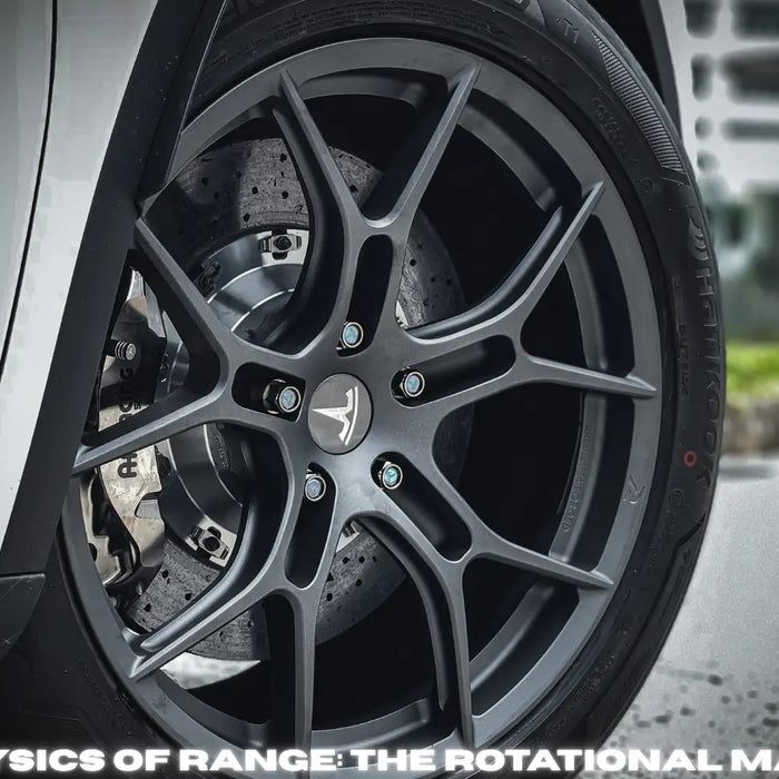 High-performance lightweight forged wheel on a modern electric vehicle in an engineering lab.